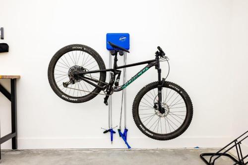 a bike hanging on a wall at Lookout Chalet NEW Build huge Party Deck Hot Tub and Trail Access in Bella Vista