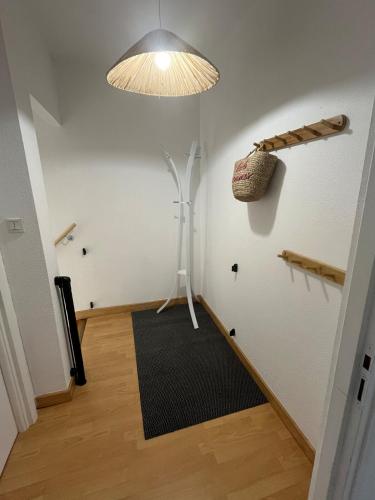 a hallway with a room with a rug and a lamp at Le Cocon de KENNA au centre du bourg in Dompierre-sur-Besbre