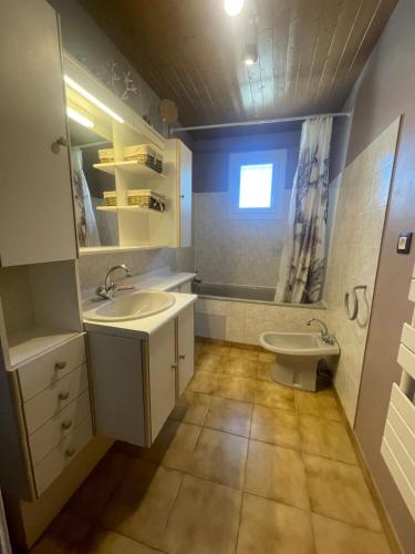 une salle de bain avec un lavabo et des toilettes dans l'établissement Maison de vacances avec piscine, à Baillargues
