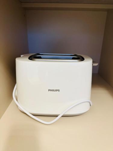a white toaster sitting on top of a counter at NEW Cozy design studio near the river in Salacgrīva