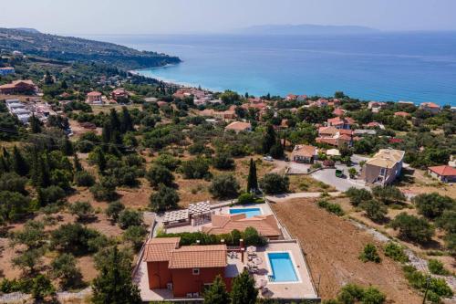 an aerial view of a house with the ocean at Villa Provenzo by Villa Plus in Lourdhata