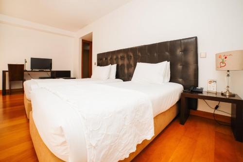 Postel nebo postele na pokoji v ubytování Eirado Hotel