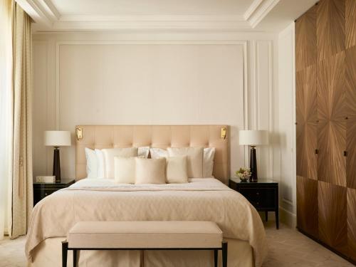a bedroom with a large bed with white pillows at The Woodward - Auberge Collection in Geneva