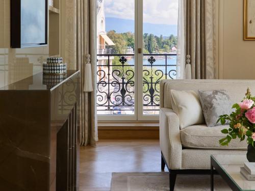 a living room with a couch and a balcony at The Woodward - Auberge Collection in Geneva
