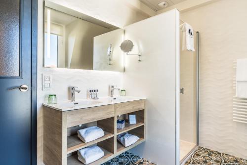 a bathroom with a sink and a mirror at MADISON Saint Jean de Luz - Handwritten Collection in Saint-Jean-de-Luz