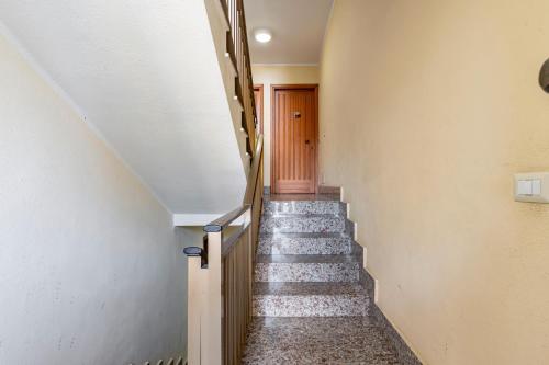 a hallway with stairs leading up to a door at GuestHost - Casa Giovanna Lungomare Sea view in SantʼAlessio Siculo