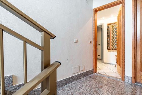 a staircase leading to a room with a door at GuestHost - Casa Giovanna Lungomare Sea view in SantʼAlessio Siculo
