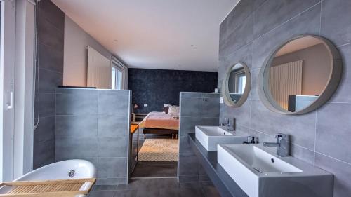 a bathroom with two sinks and a mirror at Vermont Hub for Offsites, Retreats & Individual Bookings in Alps in Leysin