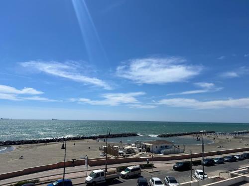 a parking lot with a beach and the ocean at Casa Romano SeaFront in Fiumicino