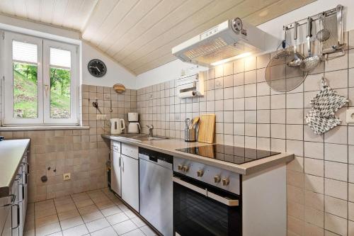 a kitchen with a sink and a stove at Altes Forsthaus - Fewo Bianca in Bad Peterstal-Griesbach