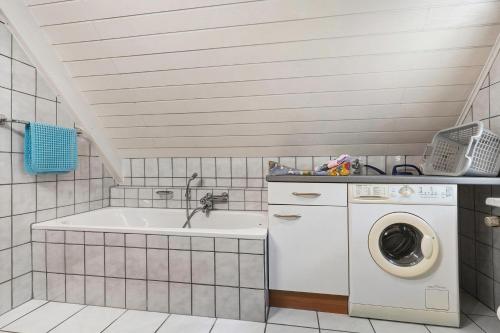 a bathroom with a washing machine and a sink at Altes Forsthaus - Fewo Bianca in Bad Peterstal-Griesbach