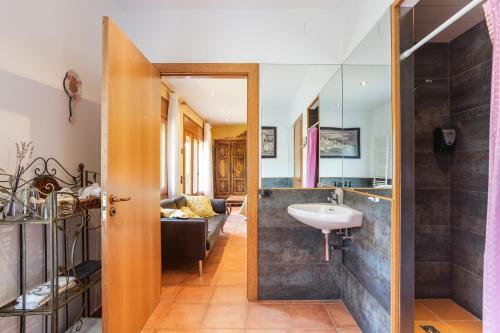 a bathroom with a sink and a mirror at Ca la Montse in Viladrau