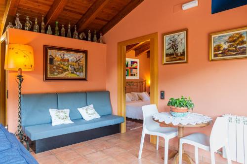 a living room with a couch and a table at Ca la Montse in Viladrau
