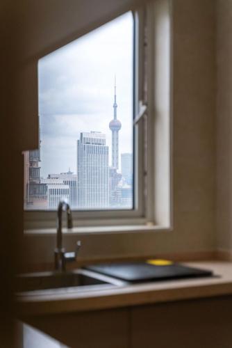 a kitchen window with a sink and a view of a city at Pure Home-Near the Bund enjoys the beautiful scenery of the Bund 3-bedhome close to Yuyuan Garden Huaihai Road and Nanjing Road Pedestrian Street in Shanghai