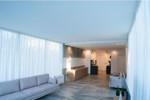 a living room with a white couch in a room at Hotel La Martinica in Ficarazzi