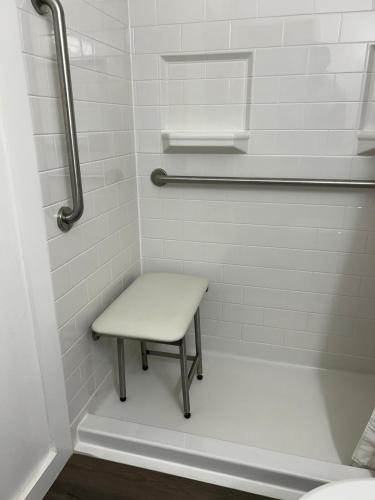 a bench in a bathroom with a shower at Hendrix Hospitality Suite in Pittsburgh
