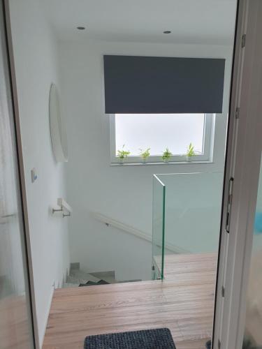 a window with a black blind in a room at Renoviertes Apartment in Troisdorf in Troisdorf