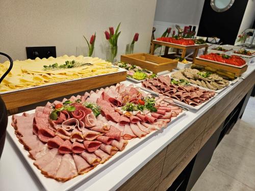a buffet with many different types of meats and cheese at Barbarka Vita w Świnoujściu in Świnoujście