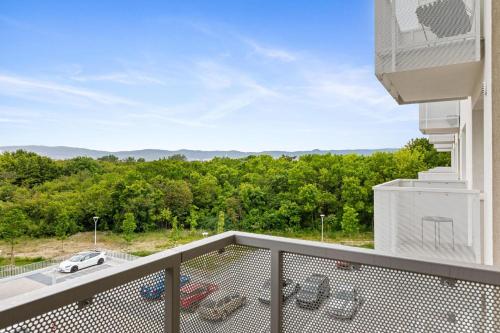a balcony with a view of a car parked on it at AH Airport PAN AM Free Parking AC in Bratislava