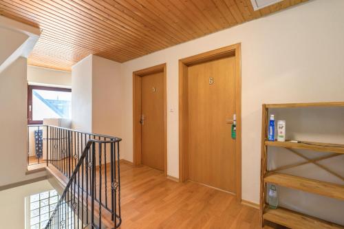 a hallway with a staircase and a wooden ceiling at Bed and Breakfast St Wendel in Prüm
