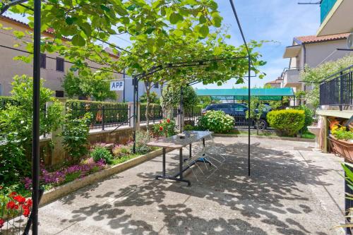 a swing in the middle of a garden at Apartments Grassi by Rent Istria in Umag