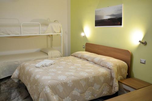 a bedroom with two beds and a bunk bed at B&B Miramare in Ascea