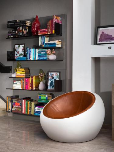 a white bowl sitting in front of a book shelf at The Atara Near Golf Course Road in Gurgaon