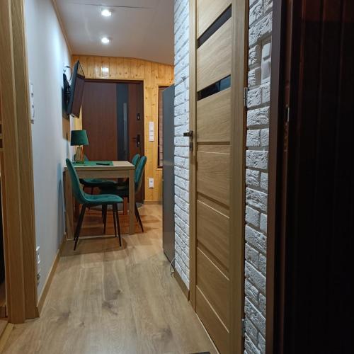 a hallway with a door and a desk in a room at Domek02 Ośrodek Wypoczynkowy Joanna Wojnowo Lubuskie in Kargowa