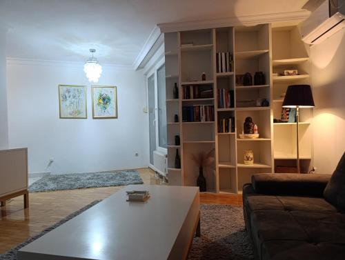 a living room with a couch and a coffee table at CityComfort Tuzla in Tuzla