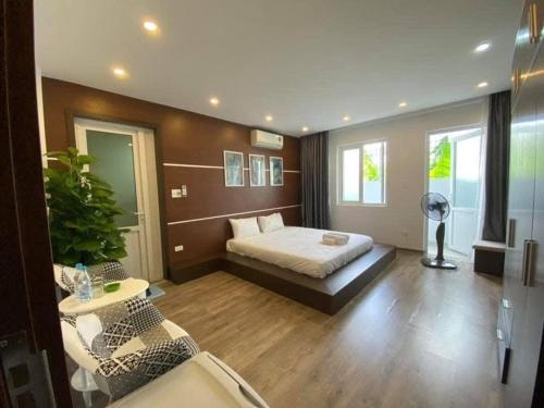 a bedroom with a bed and a table and chairs at Homestay Tự Do in Hue