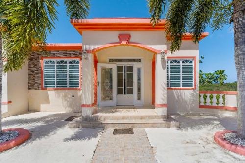 a house with palm trees in front of it at Tropical Paradise in Rincon in Aguada