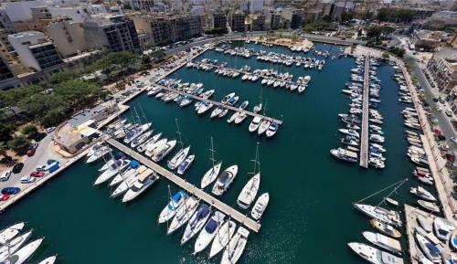 an aerial view of a harbor filled with boats at Stunning 2BR penthouse with harbour view & BBQ by 360 Estates in Tal-Pietà