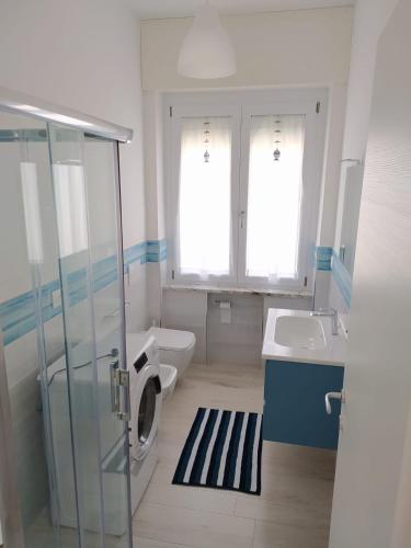 a bathroom with a shower and a toilet and a sink at A casa di Azzurra in Roseto degli Abruzzi