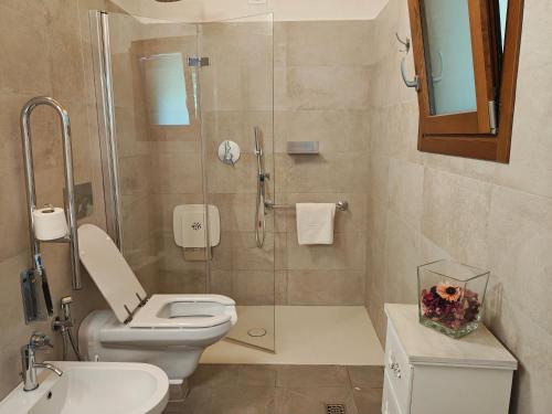 a bathroom with a shower and a toilet and a sink at Villa Torricelli Scarperia - Il Giardinetto Residence in Scarperia