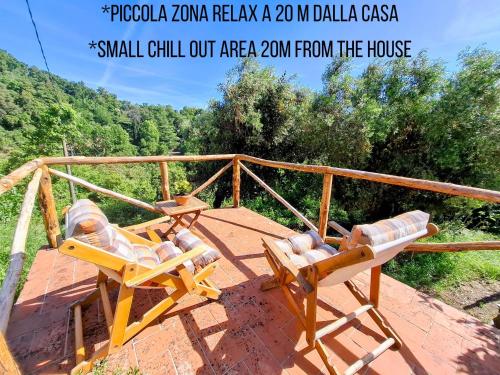 two lounge chairs sitting on top of a deck at Il Palazzo, Le Fornaci in Sassetta