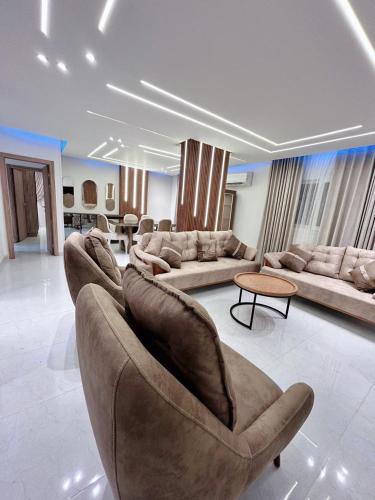 a large living room with a couch and a table at Comfy 2-Bedrooms Apartment in Cairo Sheraton airport in Cairo