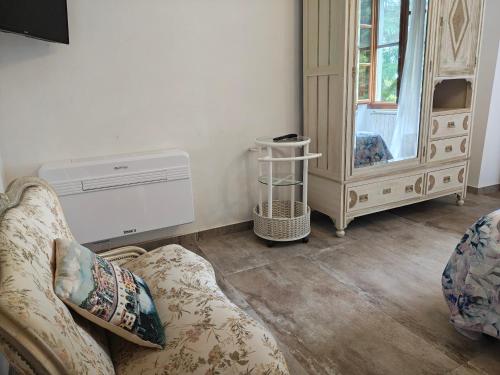 a living room with a couch and a dresser at Villa Torricelli Scarperia - Il Giardinetto Residence in Scarperia