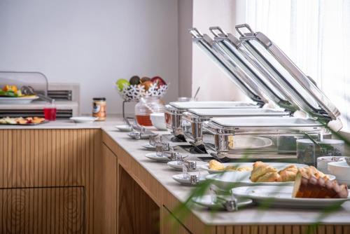 a kitchen with a counter with plates of food at Mary Hotel & Mary Royal Suites in Platanes