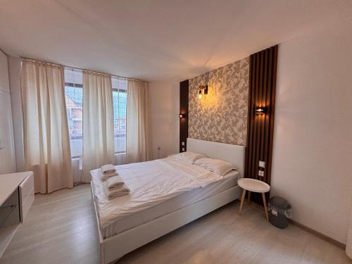 A bed or beds in a room at Sozopol Romance Apartments