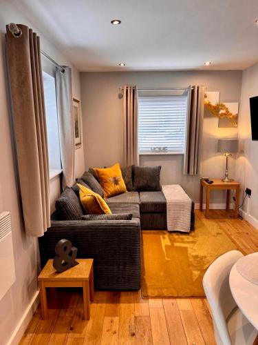 a living room with a couch and a table at Detached one bedroom house near to castle and cathedral in Lincoln