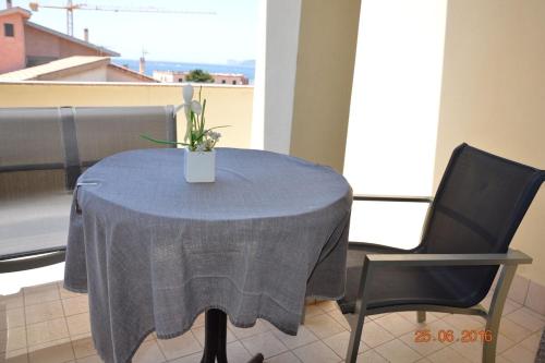a table with a blue table cloth and two chairs at Europa in Alghero