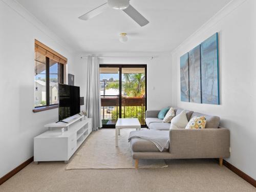 a living room with a couch and a tv at Ocean Oasis in Perth