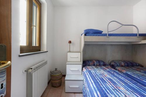 a bedroom with a bunk bed with blue sheets at Villino Flora a Viareggio in Viareggio