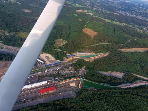 an aerial view of a highway with a wind turbine at Au Coq et fa gnes in Jalhay