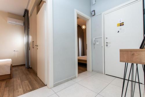 a hallway with white walls and a door to a room at Houseloft Grand Vista in Thessaloniki