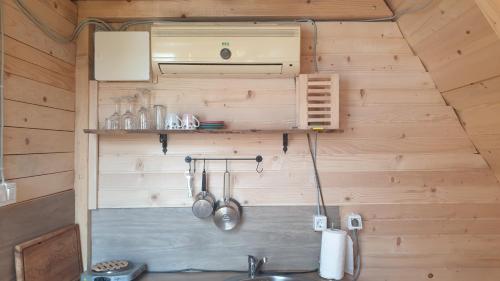a kitchen with a sink in a wooden wall at Mountain View 2 in Foča