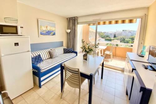 un petit salon avec un canapé et une table dans l'établissement Bright studio with balcony near the harbor, à Saint-Raphaël
