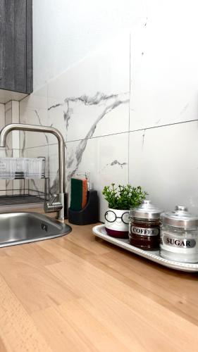 a kitchen counter with a sink and some pots and pans at Melintas cozy apartments 2 in Plomari