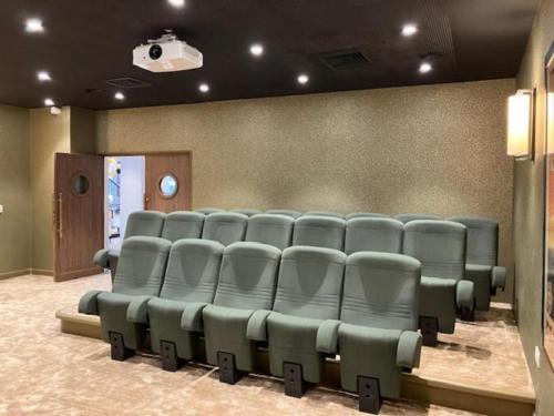 an auditorium with blue chairs in a room at Montana Dijon in Dijon