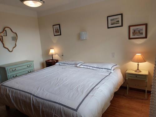 a bedroom with a bed with two night stands and two lamps at La Gineste in Serres